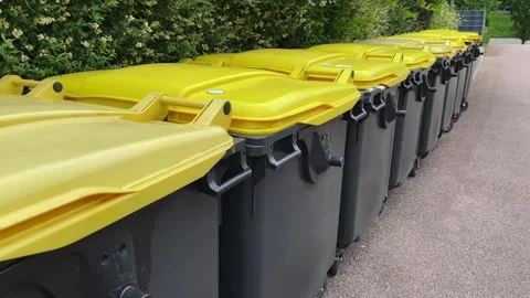 Bins with plastic waste lined up awaiting collection for recycling Stock Footage 311915504