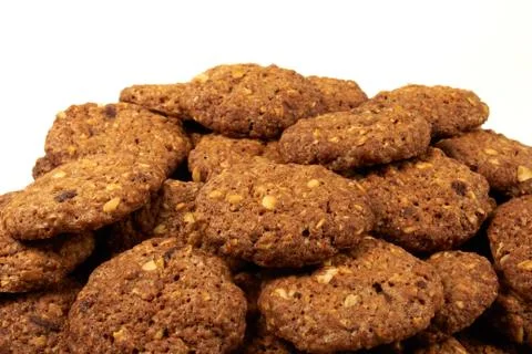 Bio cereal biscuits with chocolate chips and nuts isolated on white background 库存照片