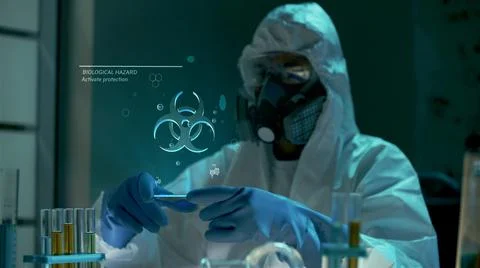 Bio engineer use virtual futuristic computer with transparent biohazard hologram 스톡 사진