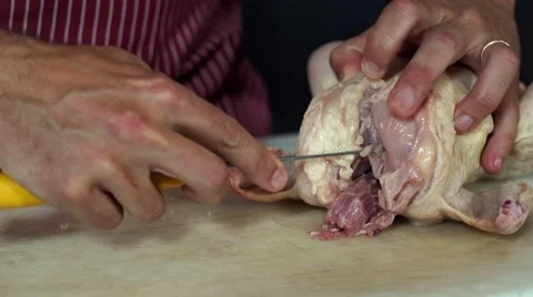 Bio food, Preparing and cleaning with knife a chicken shoulder pad in profile Stock Footage 50526313
