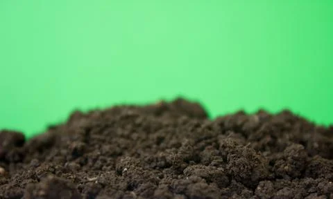 Bio ground or soil substrate as frame or border isolated on green background Stock Photos