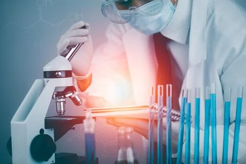 Biochemical research scientist working with a microscope for the virus,Doctor Stock Photos