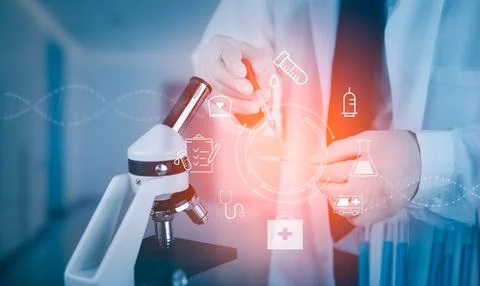 Biochemical research scientist working with microscope for coronavirus, labor Stock Photos