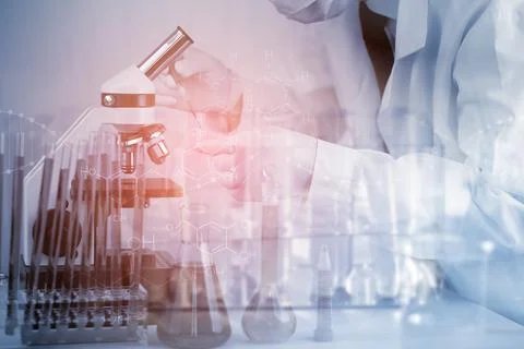 Biochemical research scientist working with a microscope for the virus,Doctor Stock Photos