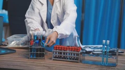 Biochemistry, scientist pipetting a sample into a test tube during an exper.. Stock Footage 290059201