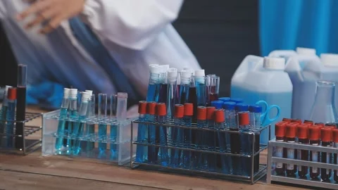 Biochemistry, scientist pipetting a sample into a test tube during an exper.. Stock Footage 290059208