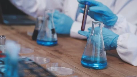 Biochemistry, scientist pipetting a sample into a test tube during an exper.. Stock Footage 290059924