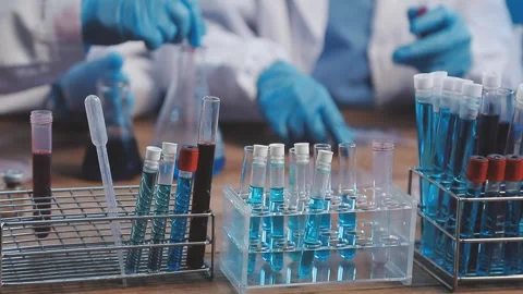 Biochemistry, scientist pipetting a sample into a test tube during an exper.. Stock Footage 290060121