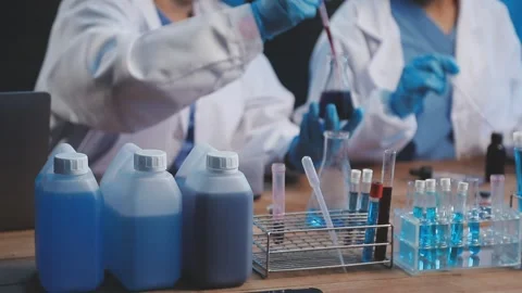 Biochemistry, scientist pipetting a sample into a test tube during an exper.. Stock Footage 290060261