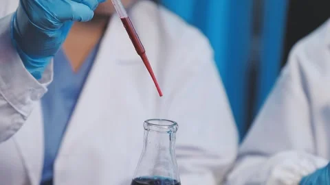 Biochemistry, scientist pipetting a sample into a test tube during an exper.. Stock Footage 290060318