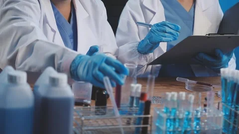 Biochemistry, scientist pipetting a sample into a test tube during an exper.. Stock Footage 290060417