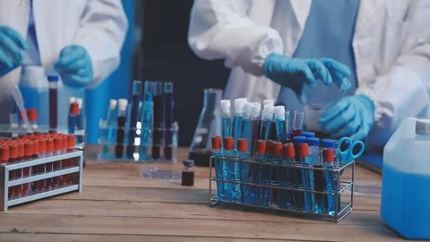 Biochemistry, scientist pipetting a sample into a test tube during an exper.. Stock Footage 290060650