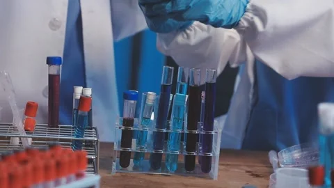 Biochemistry, scientist pipetting a sample into a test tube during an exper.. Stock Footage 290060703