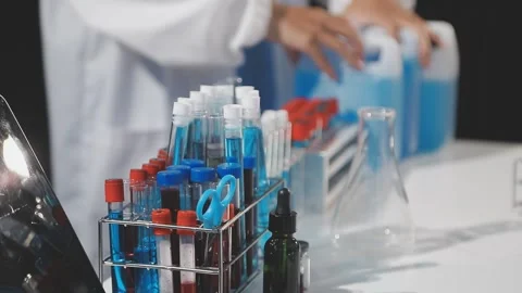 Biochemistry, scientist pipetting a sample into a test tube during an exper.. Stock Footage 290060881