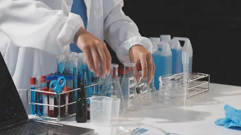 Biochemistry, scientist pipetting a sample into a test tube during an exper.. Stock Footage 290060899