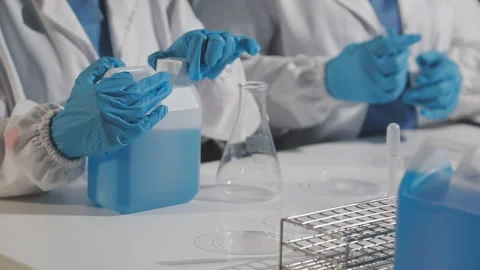 Biochemistry, scientist pipetting a sample into a test tube during an exper.. Stock Footage 290060964