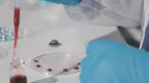 Biochemistry, scientist pipetting a sample into a test tube during an exper.. Stock Footage 290061074