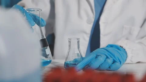 Biochemistry, scientist pipetting a sample into a test tube during an exper.. Stock Footage 290061096