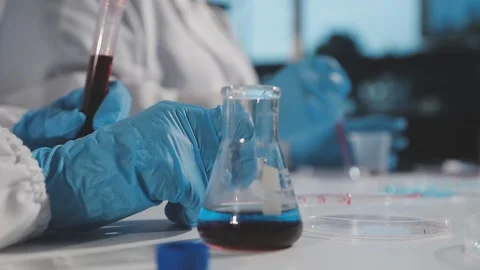 Biochemistry, scientist pipetting a sample into a test tube during an exper.. Stock Footage 290061161