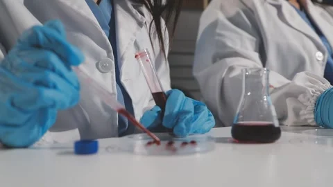 Biochemistry, scientist pipetting a sample into a test tube during an exper.. Stock Footage 290061217