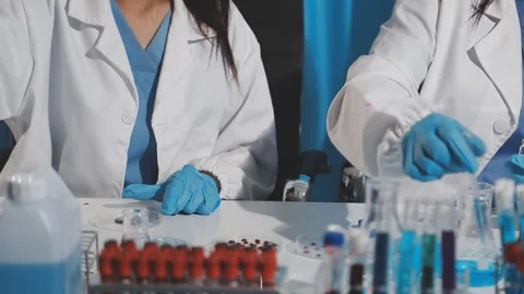 Biochemistry, scientist pipetting a sample into a test tube during an exper.. Stock Footage 290061281