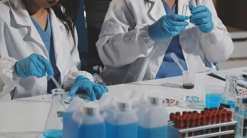 Biochemistry, scientist pipetting a sample into a test tube during an exper.. Stock Footage 290061292