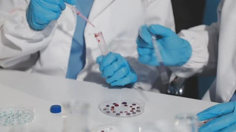 Biochemistry, scientist pipetting a sample into a test tube during an exper.. Stock Footage 290061447