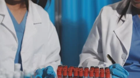 Biochemistry, scientist pipetting a sample into a test tube during an exper.. Stock Footage 290061567