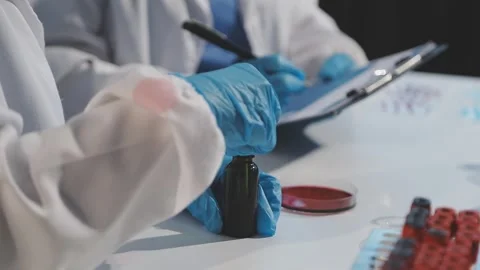 Biochemistry, scientist pipetting a sample into a test tube during an exper.. Stock Footage 290061719