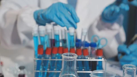 Biochemistry, scientist pipetting a sample into a test tube during an exper.. Stock Footage 290061776
