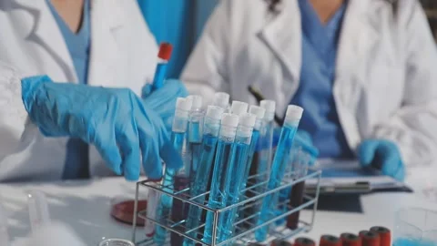 Biochemistry, scientist pipetting a sample into a test tube during an exper.. Stock Footage 290061789