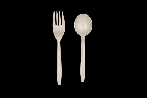Biodegradable cornstarch cookware. Eco-friendly fork and spoon isolated on bl Stock Photos