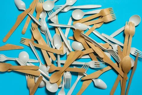 Biodegradable disposable tableware on a blue background. Stock Photos