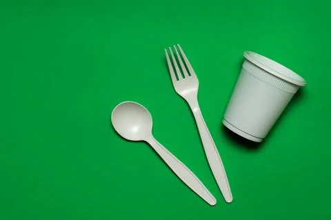 Biodegradable disposable tableware. a fork, a spoon and a glass of corn starch. Stock Photos
