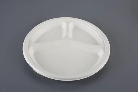 Biodegradable disposable tableware plates, glasses and spoons with forks on.. Stock Photos