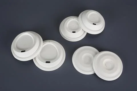 Biodegradable disposable tableware plates, glasses and spoons with forks on.. Stock Photos