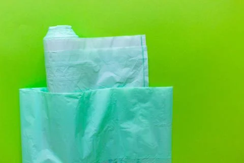 Biodegradable eco-friendly bags for trash, packages on green background. Conc Stock Photos