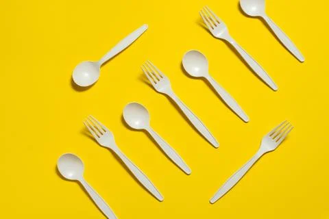 Biodegradable eco-friendly disposable tableware with a yellow background. Stock Photos