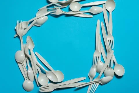 Biodegradable eco-friendly disposable tableware on a blue background. Stock Photos