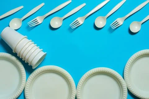 Biodegradable eco-friendly disposable tableware on a blue background. Stock Photos