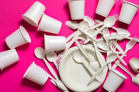 Biodegradable eco-friendly disposable tableware on a pink background. Stock Photos
