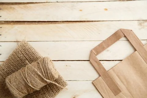 Biodegradable environmentally friendly cardboard bag on wooden background Stock Photos