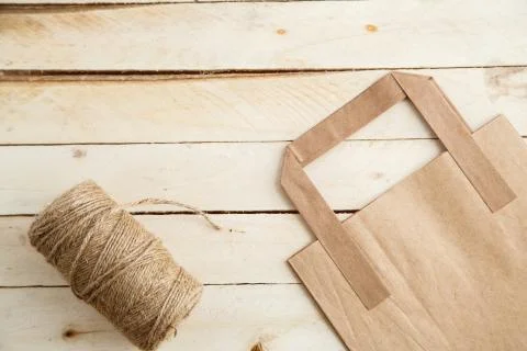 Biodegradable environmentally friendly cardboard bag on wooden background Stock Photos
