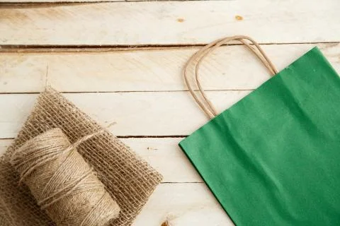Biodegradable environmentally friendly cardboard bag on wooden background Stock Photos