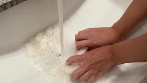 Biodegradable starch foam peanuts being dissolved in sink water Stock Footage 247404338