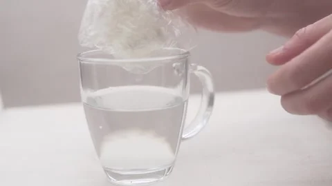 Biodegradable starch packet. A man's hand puts a seemingly plastic bag in a Stock Footage 303777375