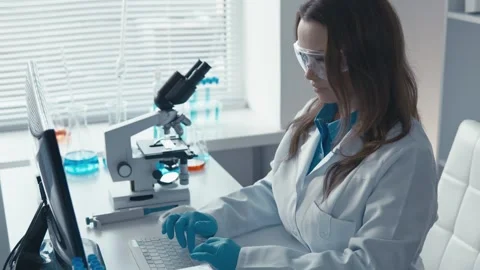 A bioengineering scientist works in a high-tech medical laboratory that uses Stock Footage 274302760