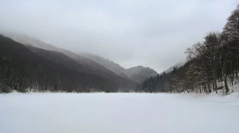 Biogradsko Lake covered with snow in the winter time Stock Footage