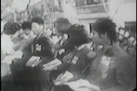 Biography of Mao Zedong being distributed amongst local people - 1969 Vídeo Stock 86694929