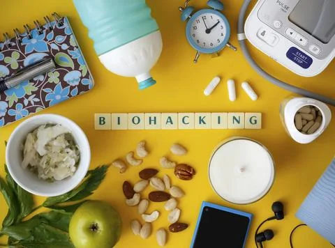Biohacking flat lay with letters "Biohacking" on yellow background Stock Photos